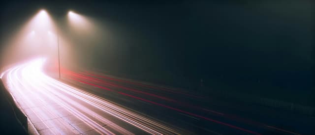 Highway traffic at night captured with long exposure light trails